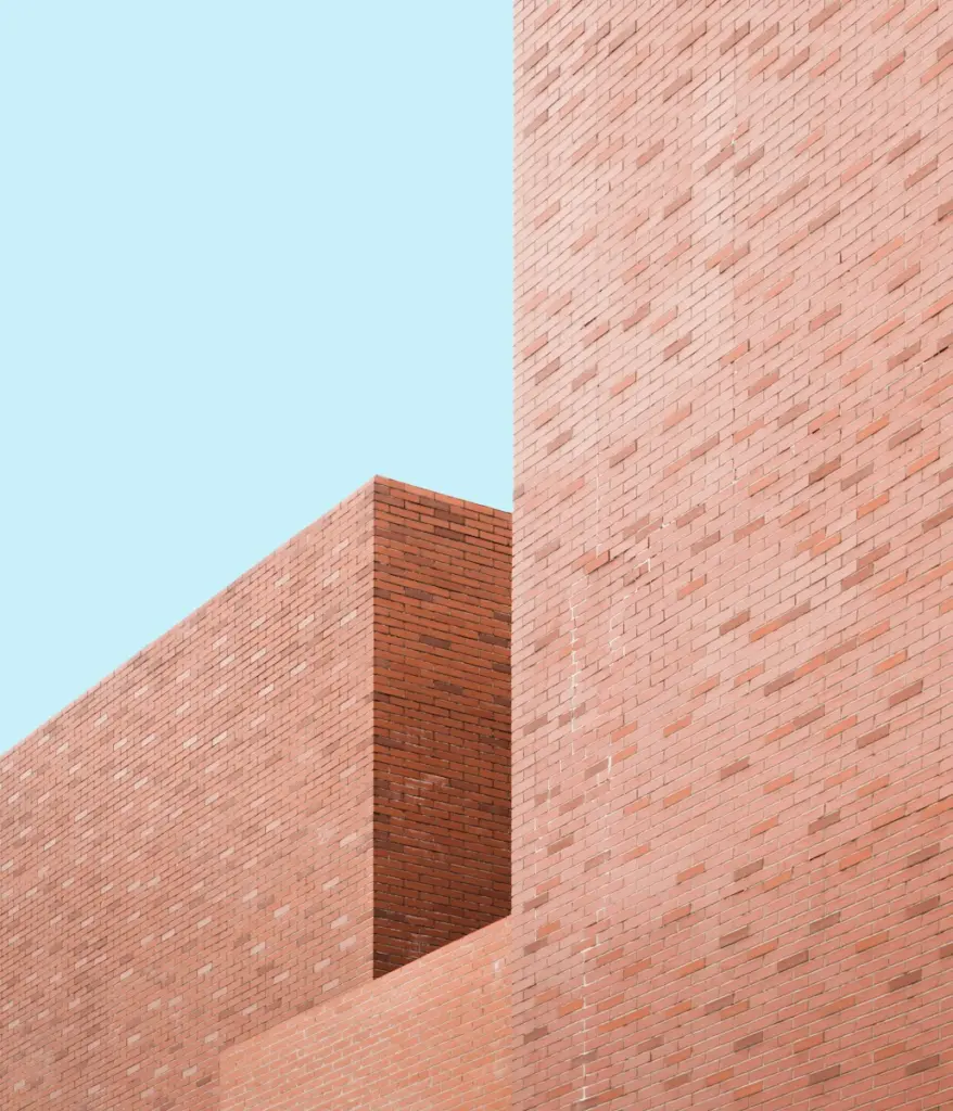 a red stop sign on the side of a brick building